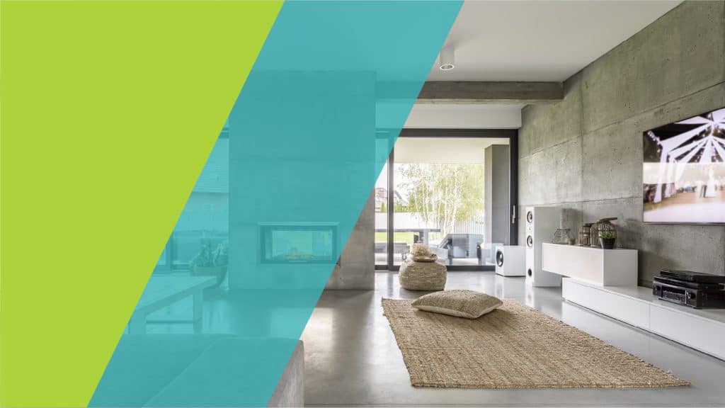 Un intérieur moderne et minimaliste avec un sol en béton, des murs en béton apparents et un salon confortable.